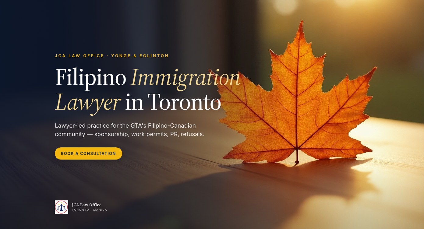 Editorial photograph of a fallen autumn maple leaf on a warm wooden desk, with overlaid headline 'Filipino Immigration Lawyer in Toronto' — JCA Law Office, Yonge & Eglinton.